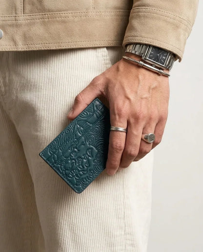Deep Teal shishi embossed card holder, held in hand