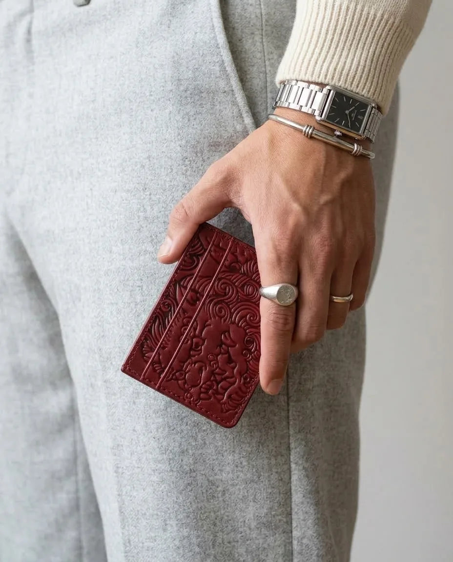 Oxblood shishi embossed card holder, held in hand